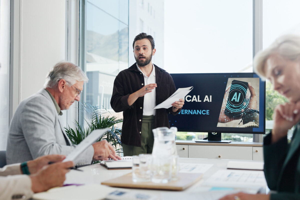 presentation-paperwork-and-businessman-in-office-2025-04-06-13-11-12-utc (1) Presentation, paperwork and businessman in office with team for AI governance system. Discussion, p.